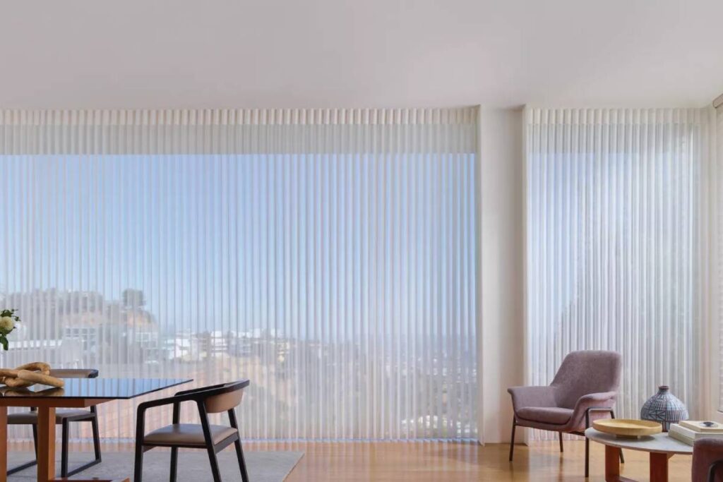 Hunter Douglas Luminette® Sheer Panels on Window Walls in a Dining Room
