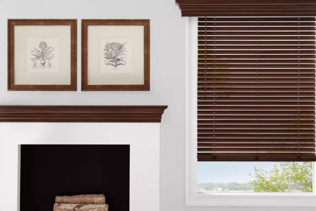 Hunter Douglas Parkland® Wood Blinds Partially Raised Next to a Fireplace at Morgan White Window Coverings