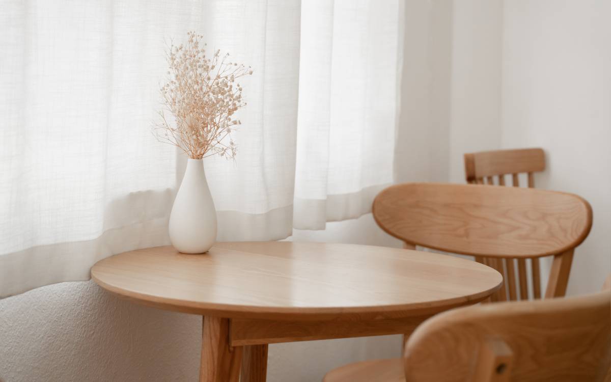 Window-length curtains near a table at Morgan White Window Coverings near Saratoga, CA