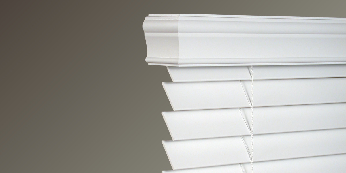 Window blinds with a valance header in a living room.